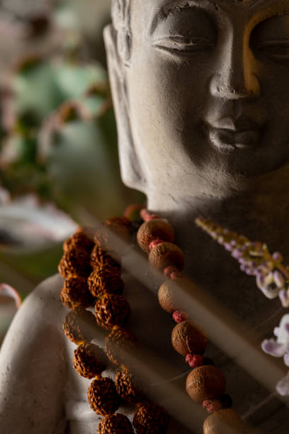 istock buddha statue image on altar with candles and plants 1393714669