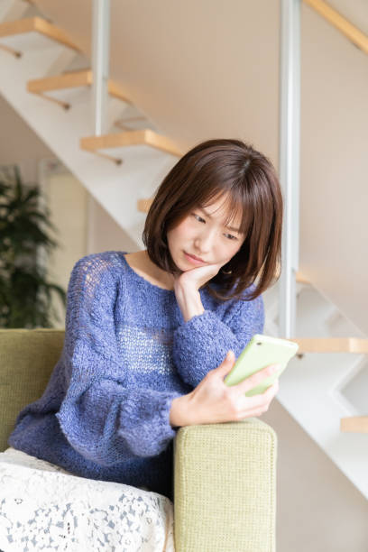istock attractive Asian woman using a smartphone,think, 1393715229