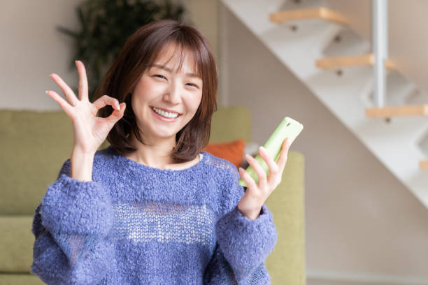 istock attractive Asian woman using a smart phone 1393715295