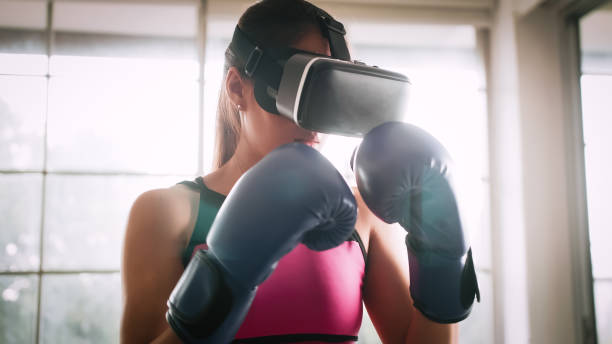 istock Young Asian woman wearing virtual reality glasses while working out at home. 1393715992