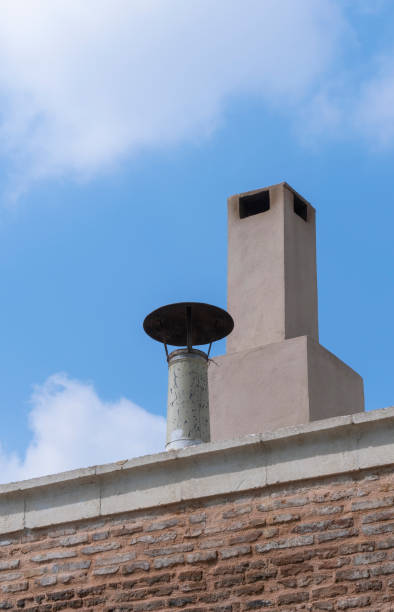 istock concrete and tin pipe chimney on the roof, 1393717680