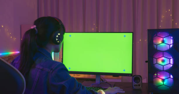 Green Screen For Cybersport Game Back view of cyber sport gamer play game with green screen monitor and powerful personal computer on the table at home neon bedroom stock pictures, royalty-free photos & images