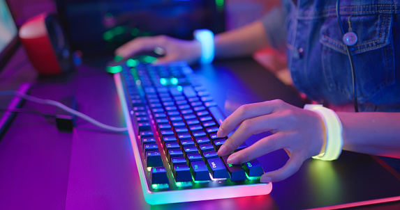 close up of pro cyber sport gamer play game with RGB keyboard and mouse