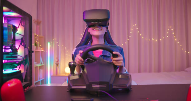 cyber sport gamer playing game front view of young asian pretty pro gamer playing racing game and wearing virtual reality headset neon bedroom stock pictures, royalty-free photos & images