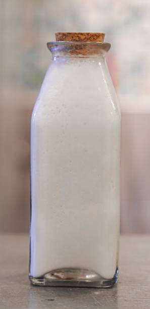istock Coconut milk yoghurt smoothie in glass bottle with cork 1393718484