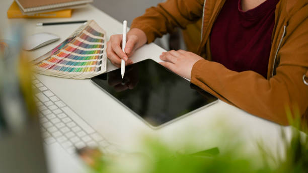 istock Cropped, Successful female graphic designer using digital graphic tablet 1393721243