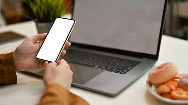 istock Female freelancer remote working at the coffee shop, using her smartphone 1393721876