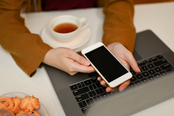 istock Top view, Female using a smartphone in her modern office desk 1393721885