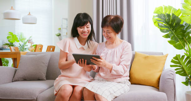istock Daughter show tablet to mom 1393724546