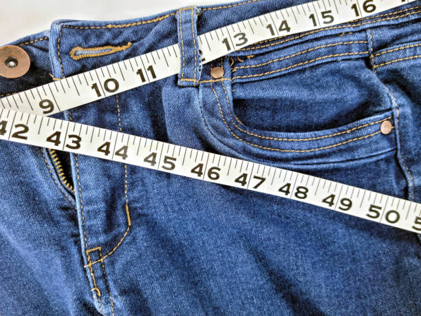 Tape Measure on Blue Jeans stock photo