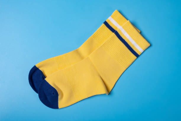 istock pair of yellow socks for boy on blue background 1393726217
