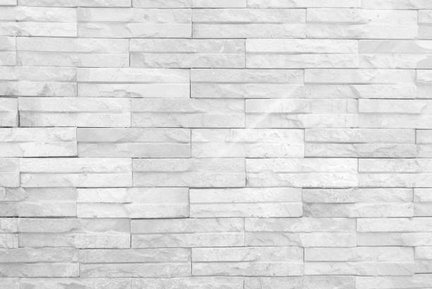 istock Seamless texture of white stone wall a rough surface, with space for text, for a background. 1393727989