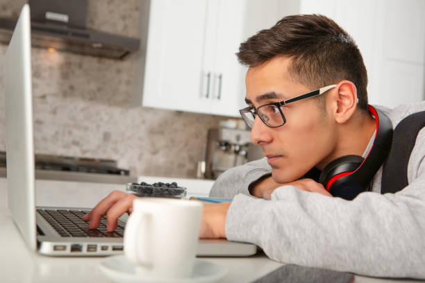 istock Teenager doing homework at home 1393730793