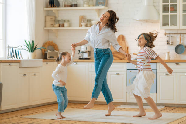 istock Mom and her daughters are dancing. 1393731957
