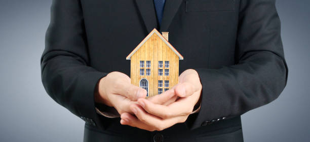 istock House Residential Structure in hand ,business home 1393734401