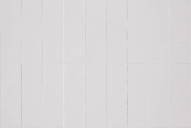 istock White ceramic wall and floor tile abstract background. Design geometric gray mosaic texture decoration of the bedroom. Simple seamless pattern grid for backdrop hospital wall, canteen and kitchen. 1393735364