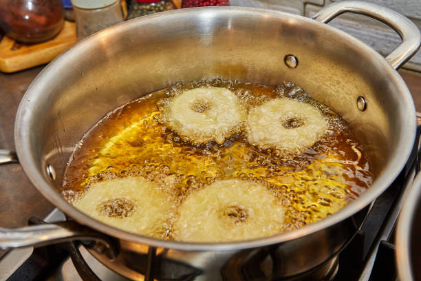istock Cooking apple pancake. Apple donut in boiling oil 1393736242