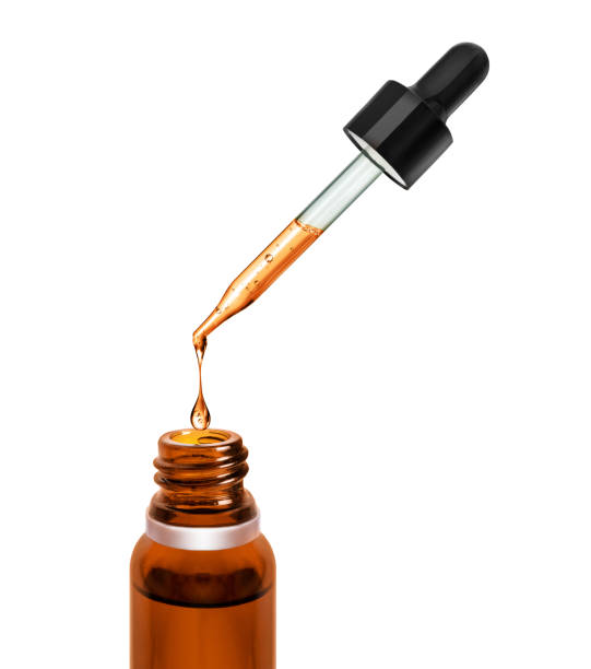 istock Drop is dripping from a pipette in a bottle 1393736276