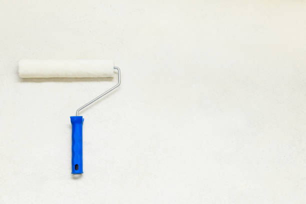istock Paint  roller on the concrete floor,  copy space. Repair tools lies on floor 1393737251