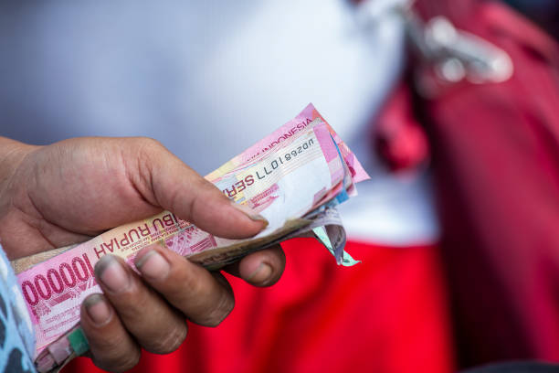 Man hands holding of Indonesian paper money, Bali, Indonesia. Currency indonesian rupee stock photo