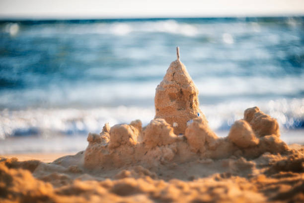 istock sand castle on the seashore. summer background 1393739645
