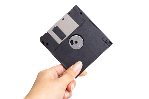 Floppy disk in hand isolated on white background close up