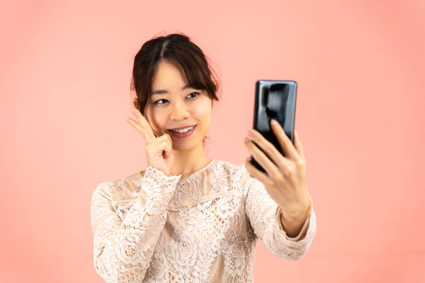 istock Young woman taking a selfie 1393746769