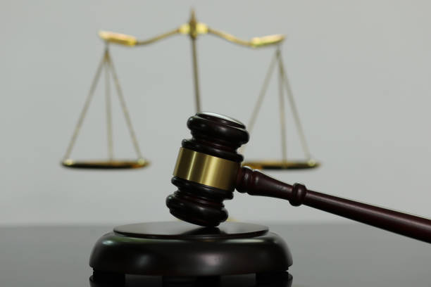 istock Judge's hammer and scales on a mirrored background. 1393747837