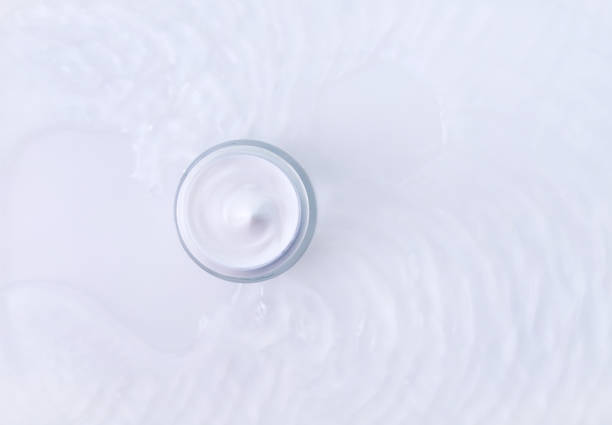 istock jar of cream in water with wave texture on light background 1393749393