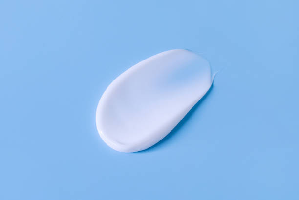 istock cosmetic smear of cream on a blue background 1393749632