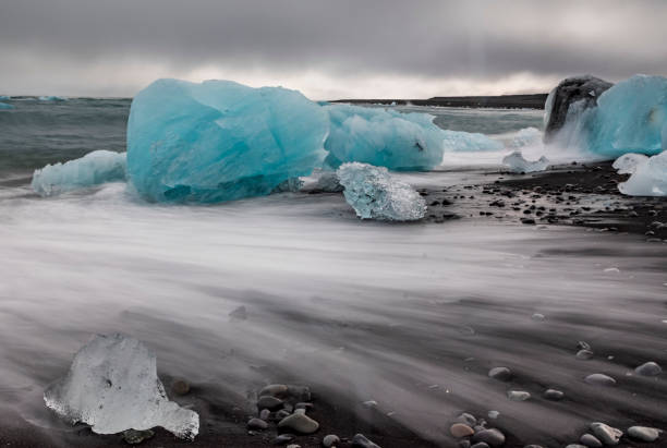 istock amazing blue colored icebergs washed ashore the black sand beach commonly named Diamond Beach in Iceland. 1393750455