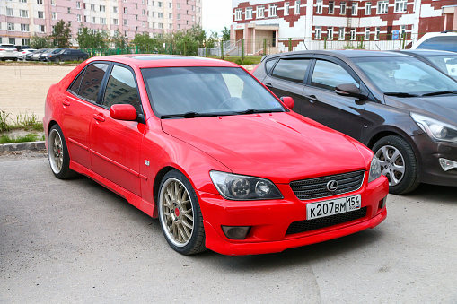 Novyy Urengoy, Russia - June 24, 2020: Red Japanese sedan Lexus IS300 in a city street.