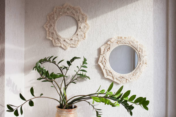 istock Macrame mirror and wreath on a white wall.  Eco-style. Natural materials. 1393752137