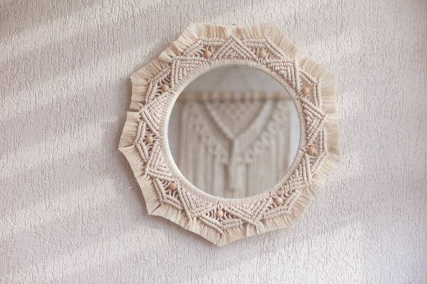 istock Macrame mirror on a white wall.  The mirror reflects macrame wallhanging. Eco-style. Natural materials. Soft fokus 1393752141