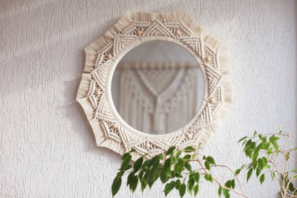 istock Macrame mirror on a white wall.  The mirror reflects macrame wallhanging. Eco-style. Natural materials. Soft fokus 1393752144