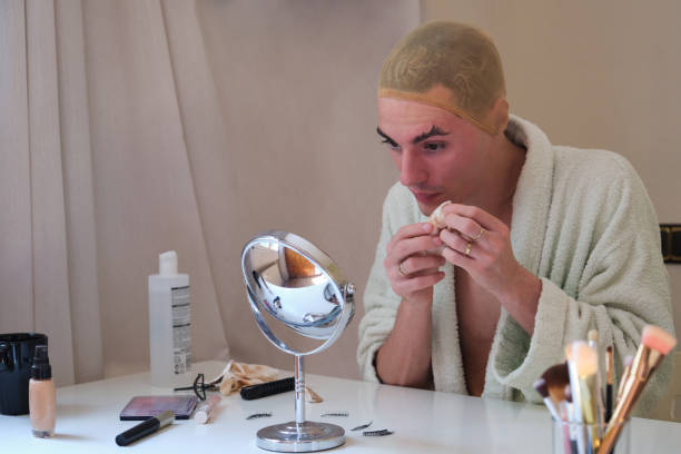 istock Drag queen person removing the make up and wearing bathrobe. 1393754507