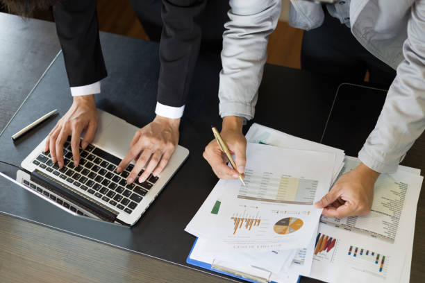 istock Business team analyzing income charts and graphs with modern laptop computer 1393756353