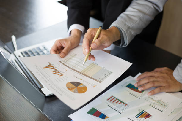 istock Business team analyzing income charts and graphs with modern laptop computer 1393756359