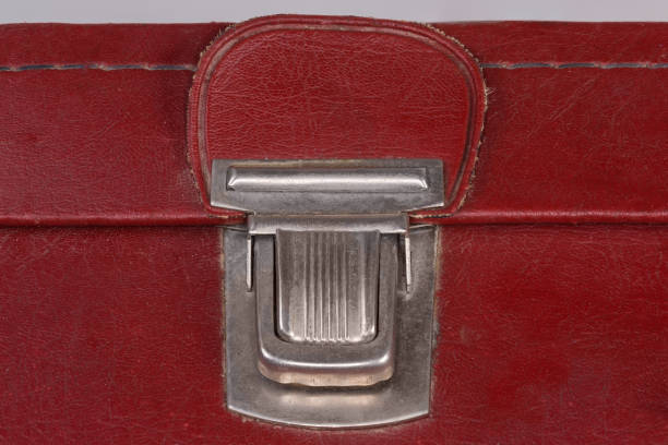 istock Push latch of the old hard-shell suitcase close-up 1393756565
