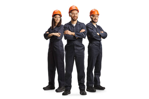 istock Team of workers in uniforms wearing helmets and goggles 1393757115