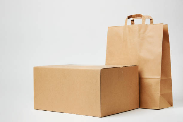 istock Cardboard box and paper bag on isolated on white 1393757185