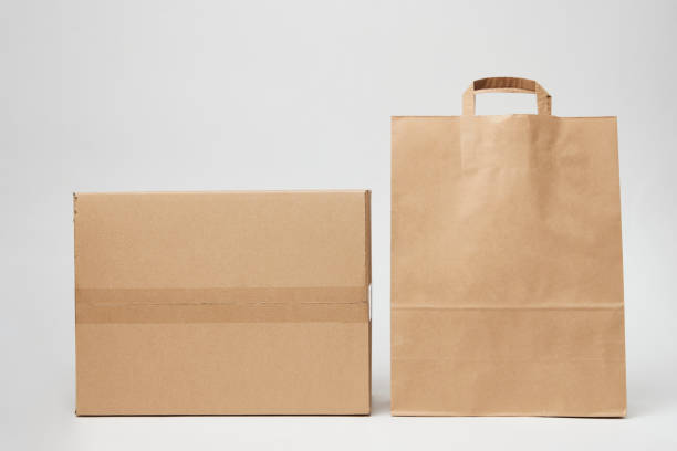istock Cardboard box and paper bag on isolated on white 1393757187