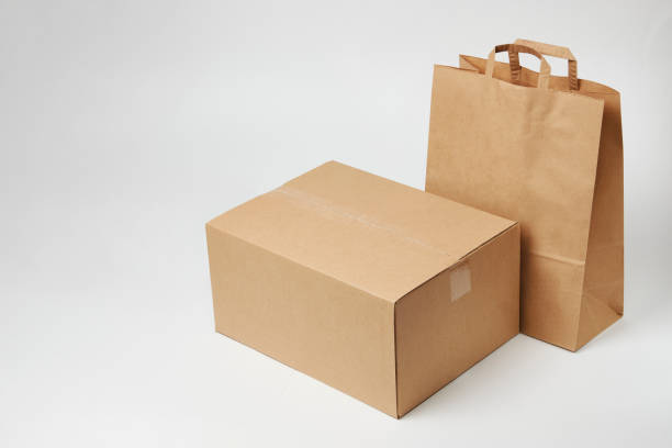 istock Cardboard box and paper bag on isolated on white 1393757192