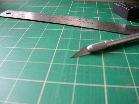 metal ruler, xacto blade and cutting mat