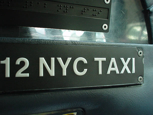 New York Taxi A Plate inside a New York taxi. new york state license plate stock pictures, royalty-free photos & images