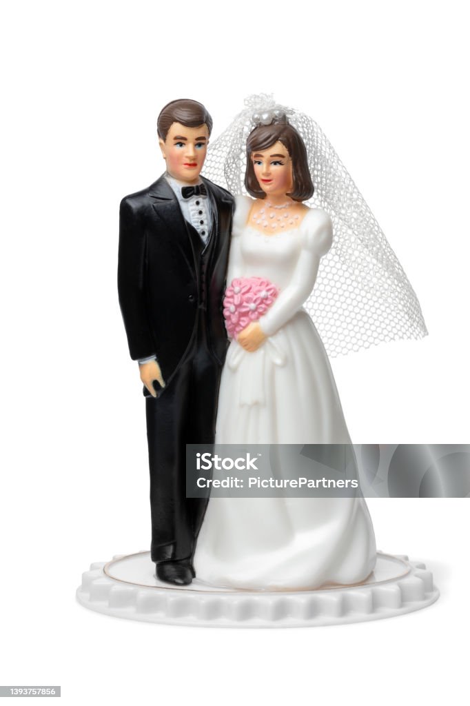 Bride and groom, classic cake topper on white background Bride and groom, classic cake topper isolated on white background Wedding Cake Figurine Stock Photo