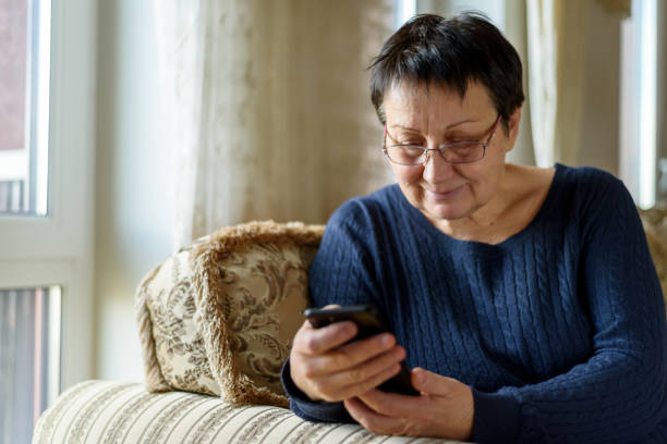 istock Senior woman using smartphone 1393758425