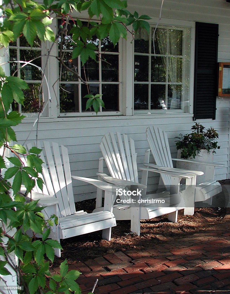 Adirondack Chairs at Country Inn Three Adirondack chairs on the porch of an inn in Meredith, New Hampshire New Hampshire Stock Photo