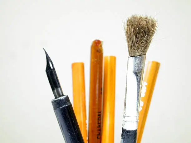 Artists' tools with the paintbrush in prime focus.  I'd love to see how it's being used.