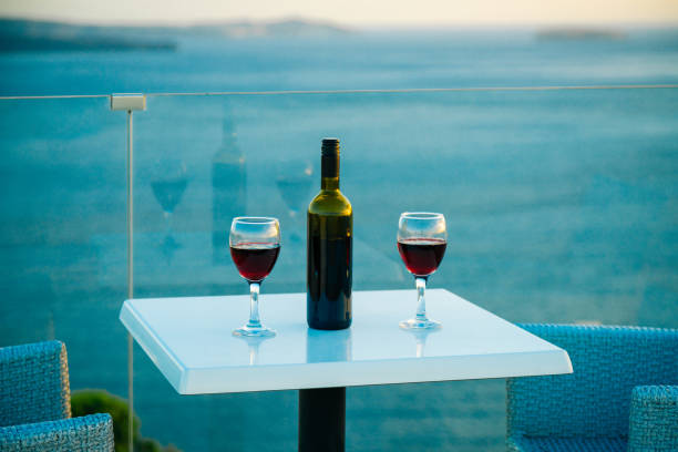 istock Wine glasses with red wine, Santorini island, Greece 1393761489